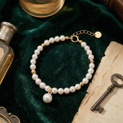Elegant Freshwater Pearl Bracelet with Gold Accents and Teardrop Pendant